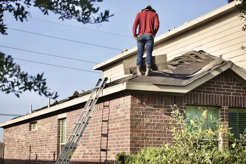 Professional roofer working on a residential roof in Larchmont Village